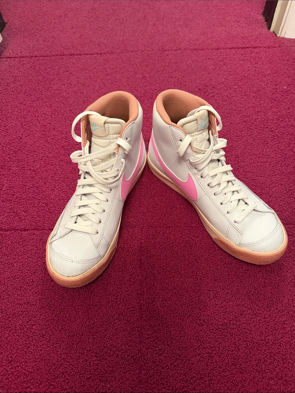 Nike Women's White Sneakers with Pink Swoosh and Peach Lining